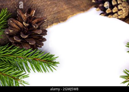 Natural green fir tree branches with needles and pine cones as a frame with white copy space for text flat lay. Stock Photo