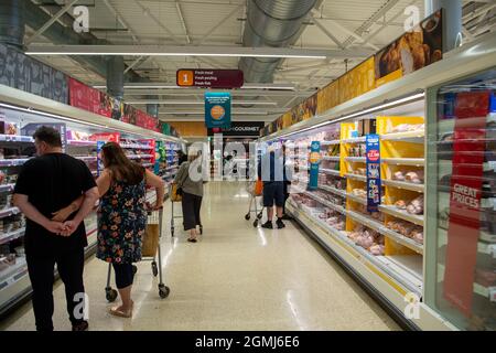 Taplow, UK. 19th September, 2021. Shoppers in the meat isle. Sainsbury's Supermarket had a good supply of food in their store today. Some lines are still being impacted upon by supply chain issues including bottled water and carbonated drinks such as cola due a shortage of carbon dioxide. This may lead to meat running short in supermarkets as animals are stunned before being slaughtered using carbon dioxide. Credit: Maureen McLean/Alamy Live News Stock Photo