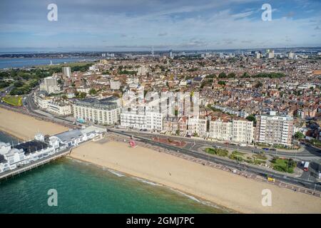 Southsea Victorian Seafront and Pier with a long stretch of beach and Southsea Common in view. Aerial view. Stock Photo