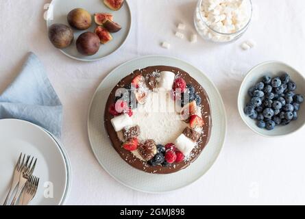 top view of cake decorated with berries, marshmallows and chocolate Stock Photo