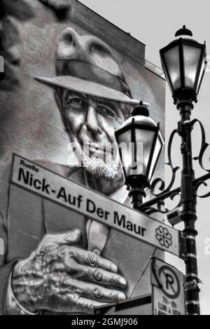 Montreal, Canada  August 9, 2019: Black and white picture of mural of Leonard Cohen with a street sign honoring Nick Auf der Maur, two Montreal icons, Stock Photo