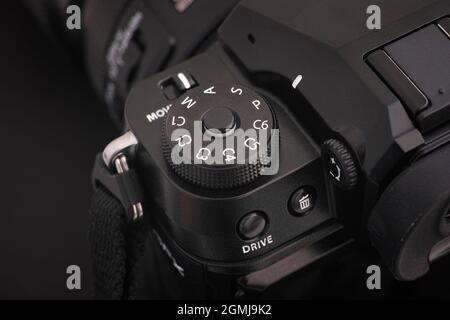 Tambov, Russian Federation - July 19, 2021 A Close-up shot of the PSAM dial of the Fujifilm GFX 100S medium format camera on a black background. Low k Stock Photo