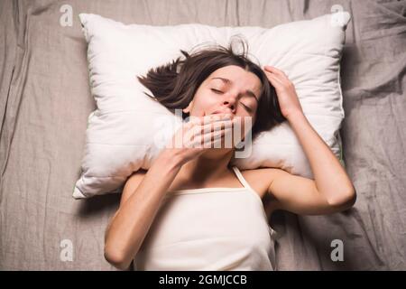 A young girl woke up in the morning in bed  Stock Photo