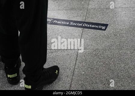 New York, USA. 18th Sep, 2021. Social distancing reminders and indicators are evident at JFK Airport queues. Credit: Nir Alon/Alamy Live News Stock Photo