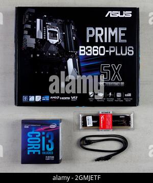 Maykop, Russia - November 9, 2018: Asus motherboard in box, intel I3 processor, Kingston Fury HyperX 16GB RAM and cable for connecting SATA 6gbs devic Stock Photo