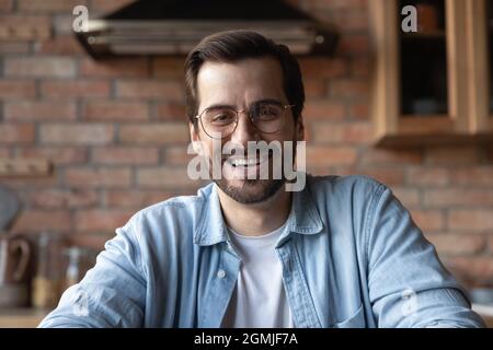 Head shot portrait smiling bearded man in glasses talking Stock Photo