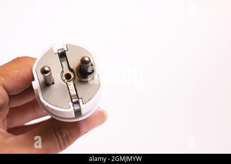Burnt electrical plug in hand isolated on white background, copy space Stock Photo