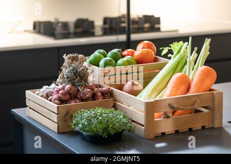 Group of vegetable Carrot, Potato, Lime, Tomato, Onion, Shallot bundle, Garlic bundle and Micro Herb in wood box. It's shot in studio light. Stock Photo