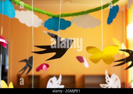 Paper decor of butterflies and birds hanging close up Stock Photo