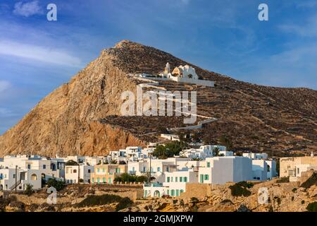 the Greek village of Chora on the island of Chora and the Church of Panagia on the hillside with a winding pathway going from the town to the church Stock Photo