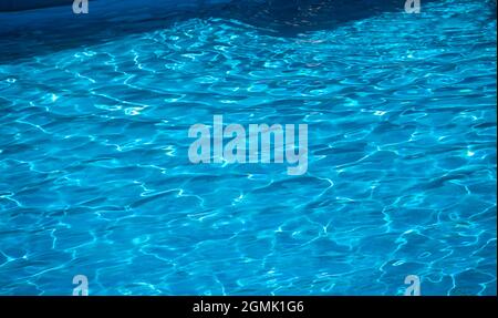 sun reflecting on the water in a pool with gentle ripples Stock Photo
