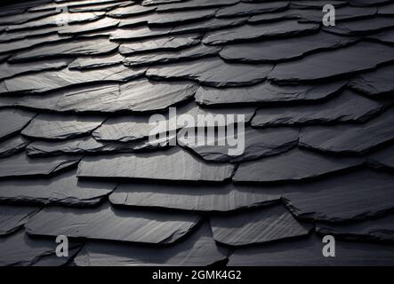 Dark gray abstract scaly background. Black natural slate roof. Stock Photo