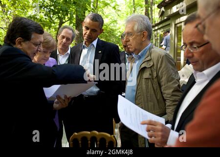 President Barack Obama talks with José Manuel Barroso, President of the European Commission, Chancellor Angela Merkel of Germany, Prime Minister Mario Monti of Italy, President François Hollande of France, and Herman Van Rompuy, President of the European Council, on the Laurel Cabin patio before the start of a G8 Summit working session at Camp David, Md., May 19, 2012. Mike Froman, Deputy NSA for International and Economic Affairs, listens in the background, third from left. (Official White House Photo by Pete Souza) This official White House photograph is being made available only for publica Stock Photo