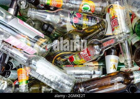 Close up view of empty glass beer bottles ready to be taken to a recycling centre. Stock Photo