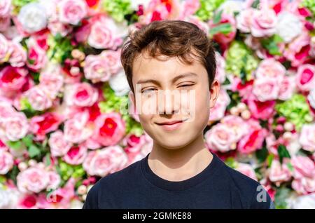 A portrait of a boy shot against a slower wall background. Stock Photo