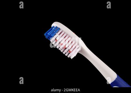 Closeup of toothbrush isolated on Dark background, close up Stock Photo