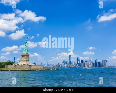 Iconic New York City view from Staten Island ferry over Statue of liberty and lower Manhattan. Stock Photo