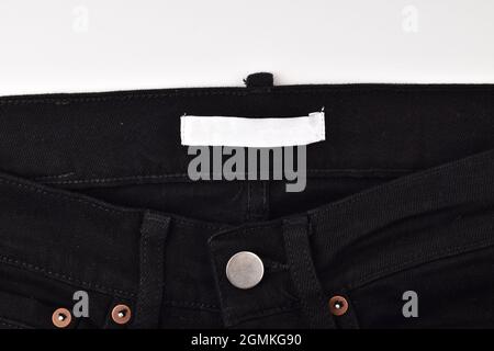 blank Clothes label in black jeans isolated on background Stock Photo