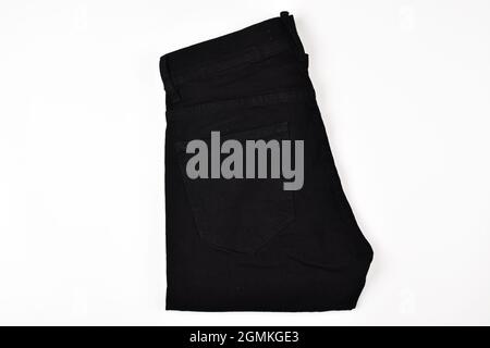 Folded black jeans isolated on white background with clipping path Stock Photo