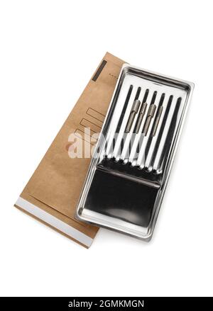 Container with clean manicure tools on white background Stock Photo