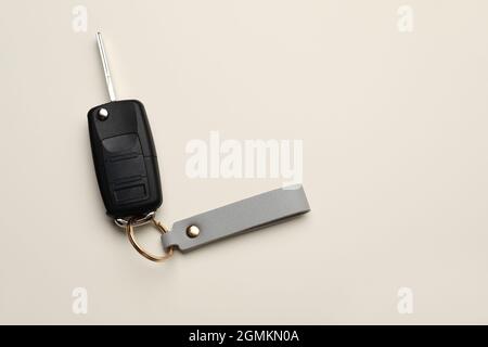 Car key with leather keychain on light background Stock Photo