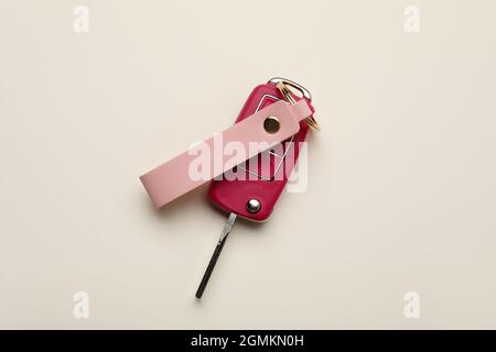 Car key with leather keychain on light background Stock Photo