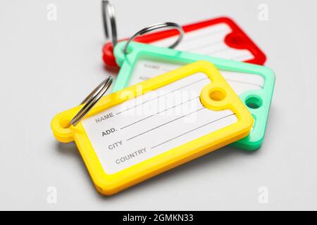 Plastic key tags on grey background, closeup Stock Photo
