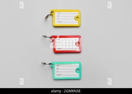 Plastic key tags on grey background Stock Photo
