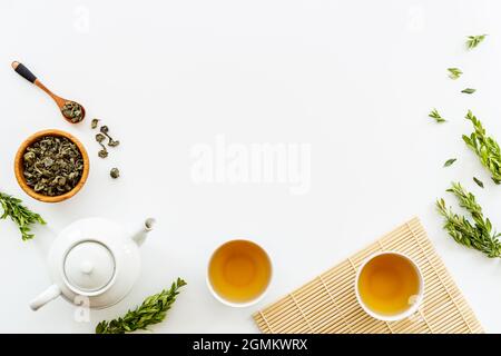 Asian food and drink set white teapot and black tea in two cups Stock Photo