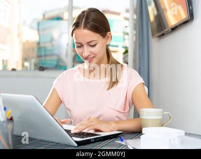 Female using laptop at home Stock Photo