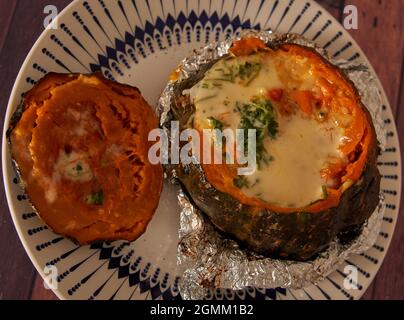 Delicious stuffed pumpkin stuffed pumpkin baked in the oven with aluminum foil. horizontal Stock Photo