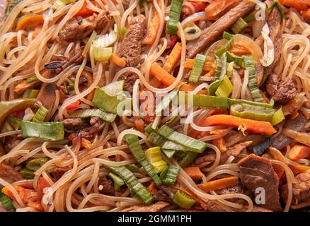 closeup wok of stir fry rice noodles stewing with vegetables. Thai food. horizontal