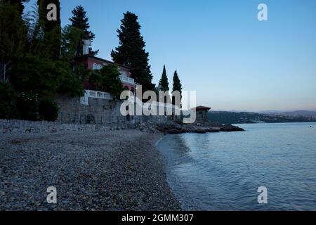 Rijeka, Croatia - August 11, 2021: Evening sea view with rocky beach. Coast of the Adriatic Sea in a resort in Croatia. Stock Photo