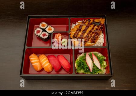 Sushi menu tray with wakame salad, Norwegian salmon nigiri and red tuna, Japanese rice maki with tuna and salmon, nori seaweed Chicken fillet breaded Stock Photo