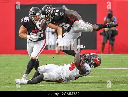 Tampa, United States. 19th Sep, 2021. Tampa Bay Buccaneers' Lavonte David (54) grabs Atlanta Falcons running back Mike Davis (28) as tight end Parker Hesse (46) looks on during the second half at Raymond James Stadium in Tampa, Florida on Sunday, September 19, 2021. Photo by Steve Nesius/UPI Credit: UPI/Alamy Live News Stock Photo