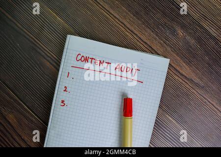Content Audit write on a book with keywords isolated on Wooden Table. Stock Photo