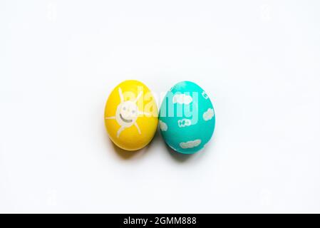 A set of colored Easter eggs painted like smiling sun and blue sky. Stock Photo