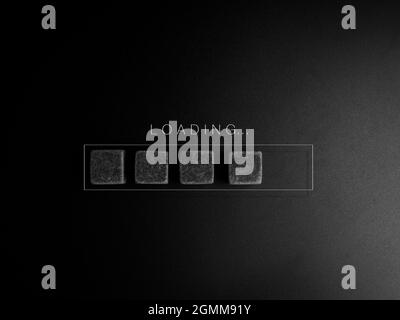 Loading concept. Loading..., word and black cubes blocks in the progress bar on dark background. Business for act updating something someone or update Stock Photo