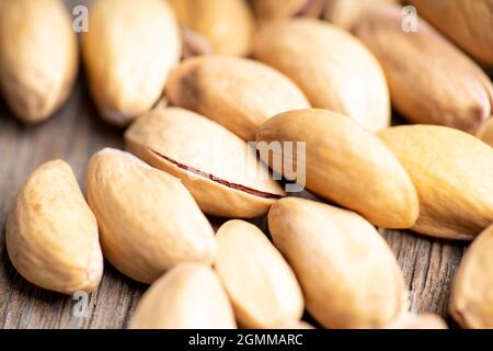 Pistachios in shell on the black rustic background. Selective focus. Shallow depth of field. Stock Photo