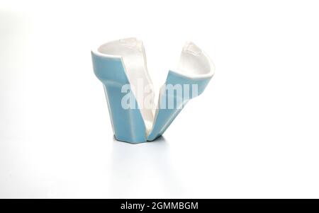 Broken blue teacup isolated on white background. Stock Photo
