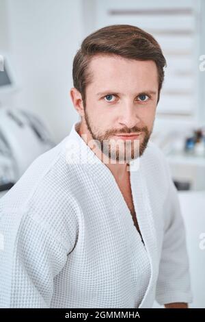 Handsome dark-haired male client in a wellness center Stock Photo
