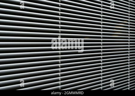 Blinds background. Window with metal shutters in the interior of the living room. High quality photo Stock Photo