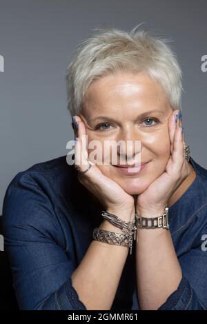Portrait smiling woman with short hair and bracelets Stock Photo