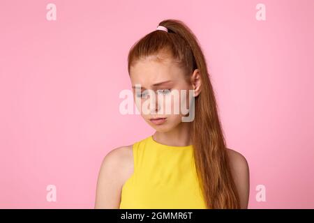 sad teen girl on green background. Human emotions Stock Photo