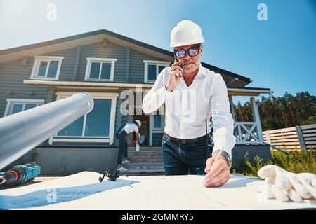 Concentrated housebuilder making notes on house layout Stock Photo