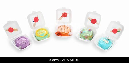 set of colorful cakes in containers isolated on white Stock Photo