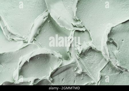 Green cosmetic clay mask texture close up. Abstract background, selective focus. Stock Photo