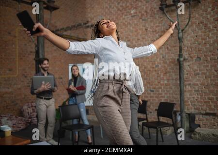 Cheerful young businesspeople having fun in office, cooperation and brainstorming concept. Stock Photo