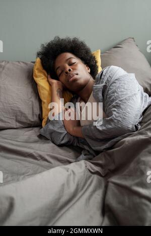 A tired plus size woman is lying on a mat in the living room, sports  equipment around her Stock Photo - Alamy