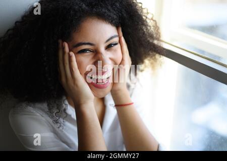 Close-up portrait of young woman indoors, looking at camera. Stock Photo